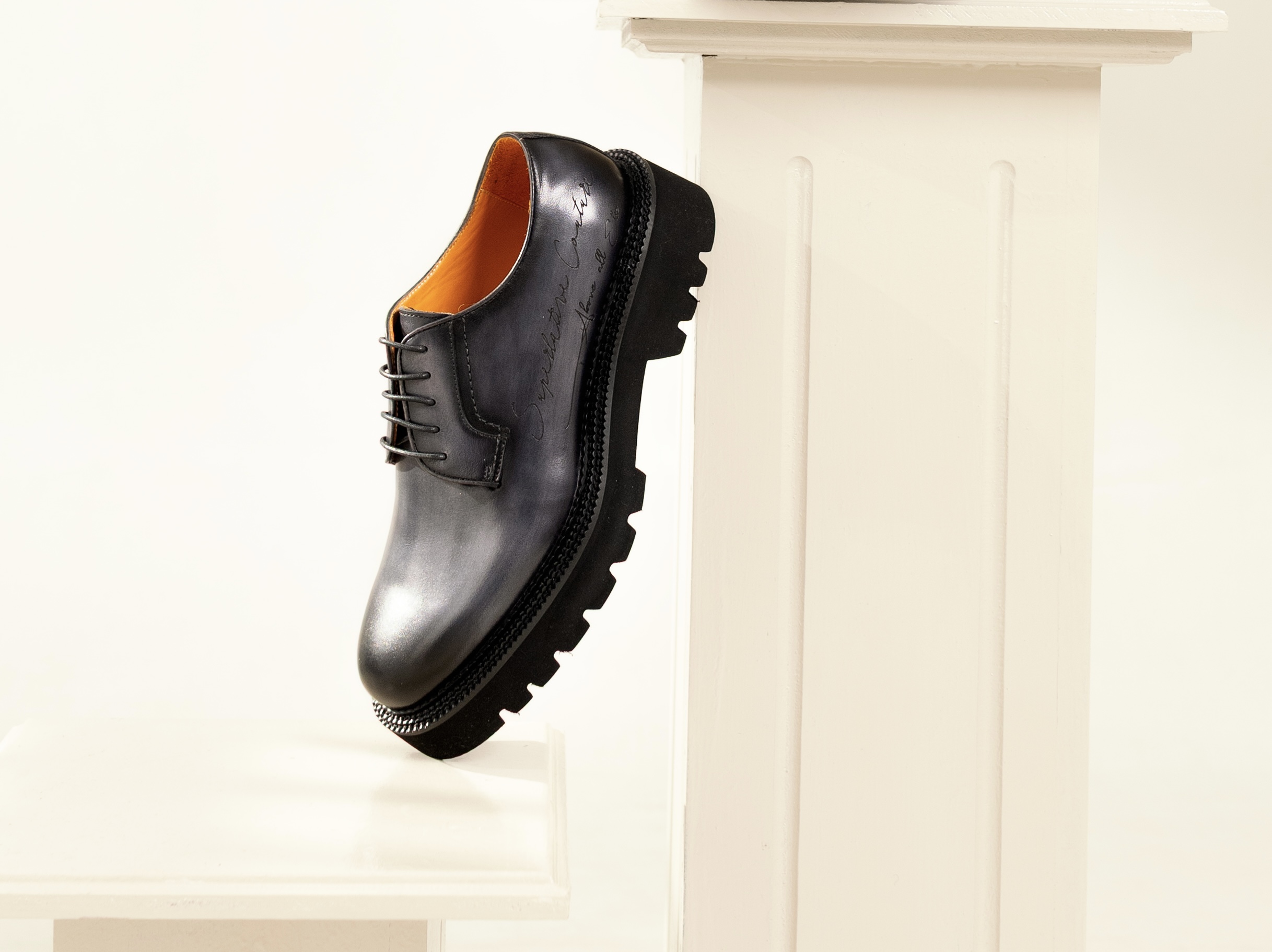 A hand-lasted leather shoe from the upcoming collection, styled on a pedestal display