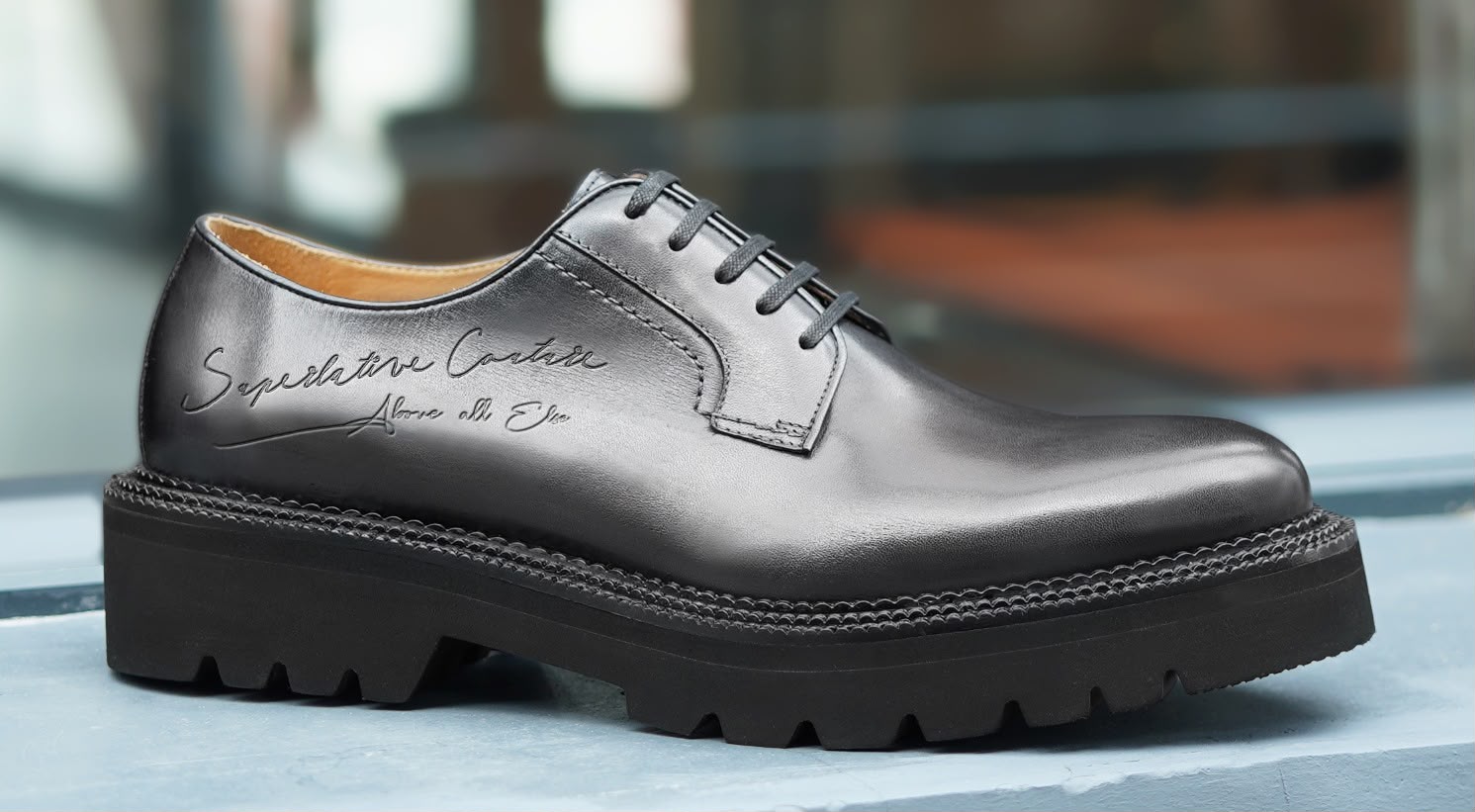 Close detail of a hand-finished black leather shoe